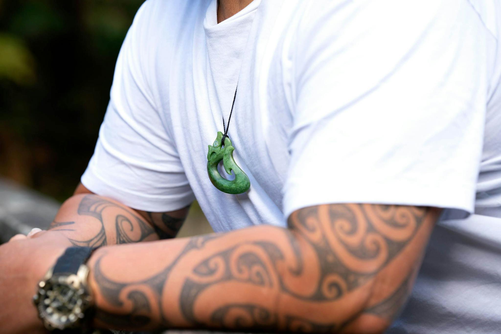 Maori man with ta moko wears Manaia pendant