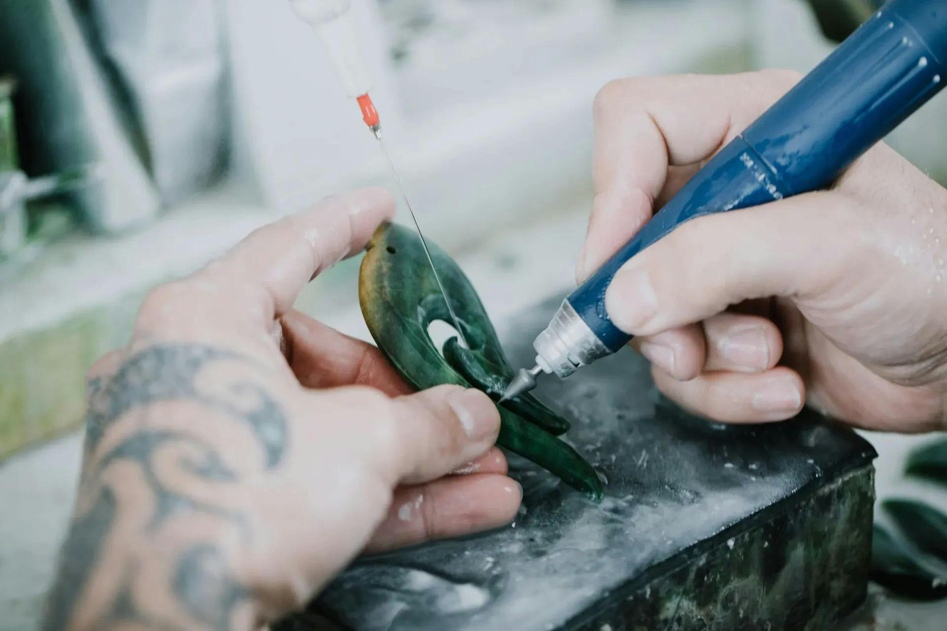carving details into a jade piece