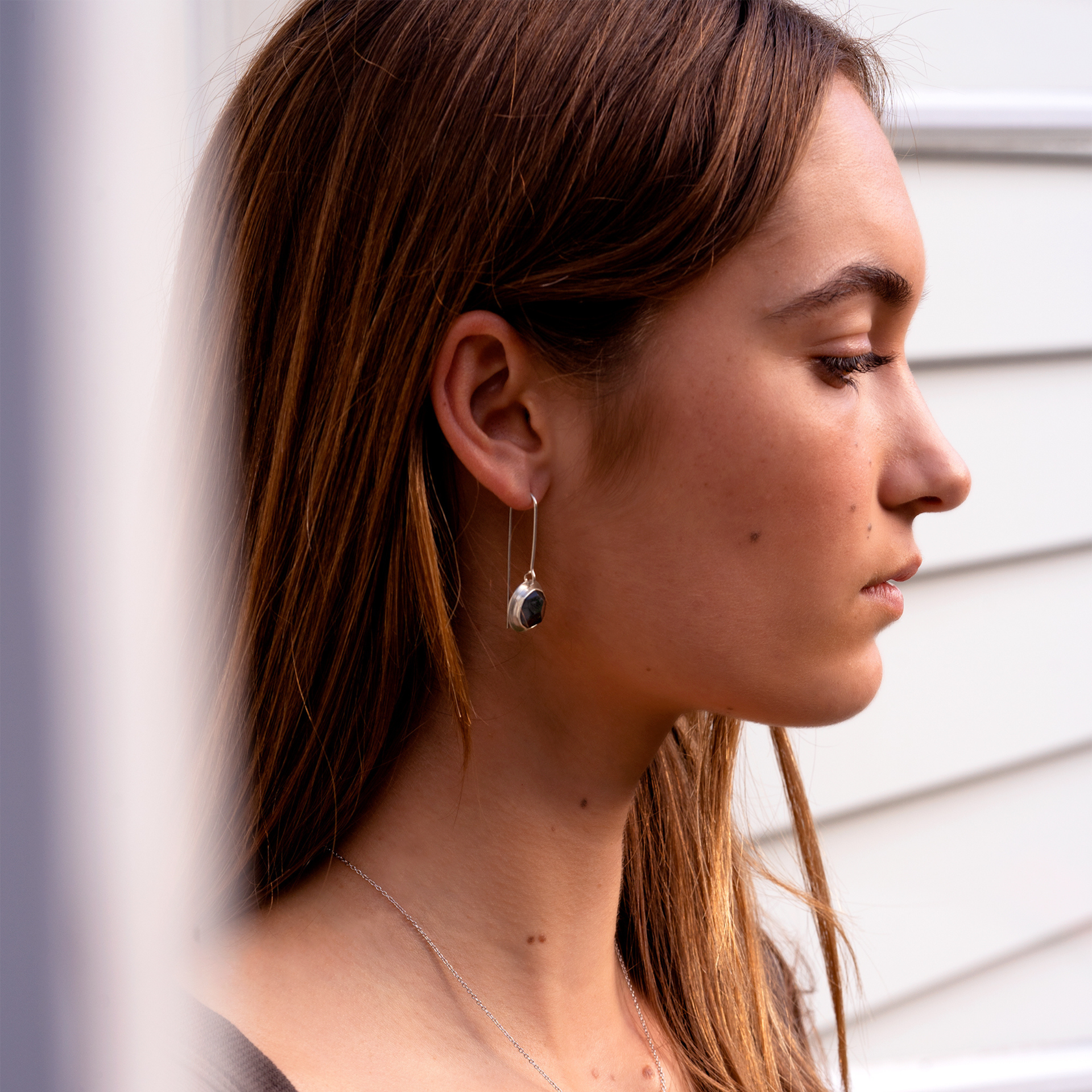 Australian Black Jade Faceted Drop Earrings - Stirling Silver Edge on model