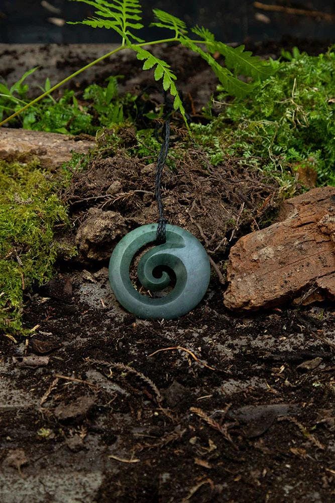 Koru necklace on the forest floor