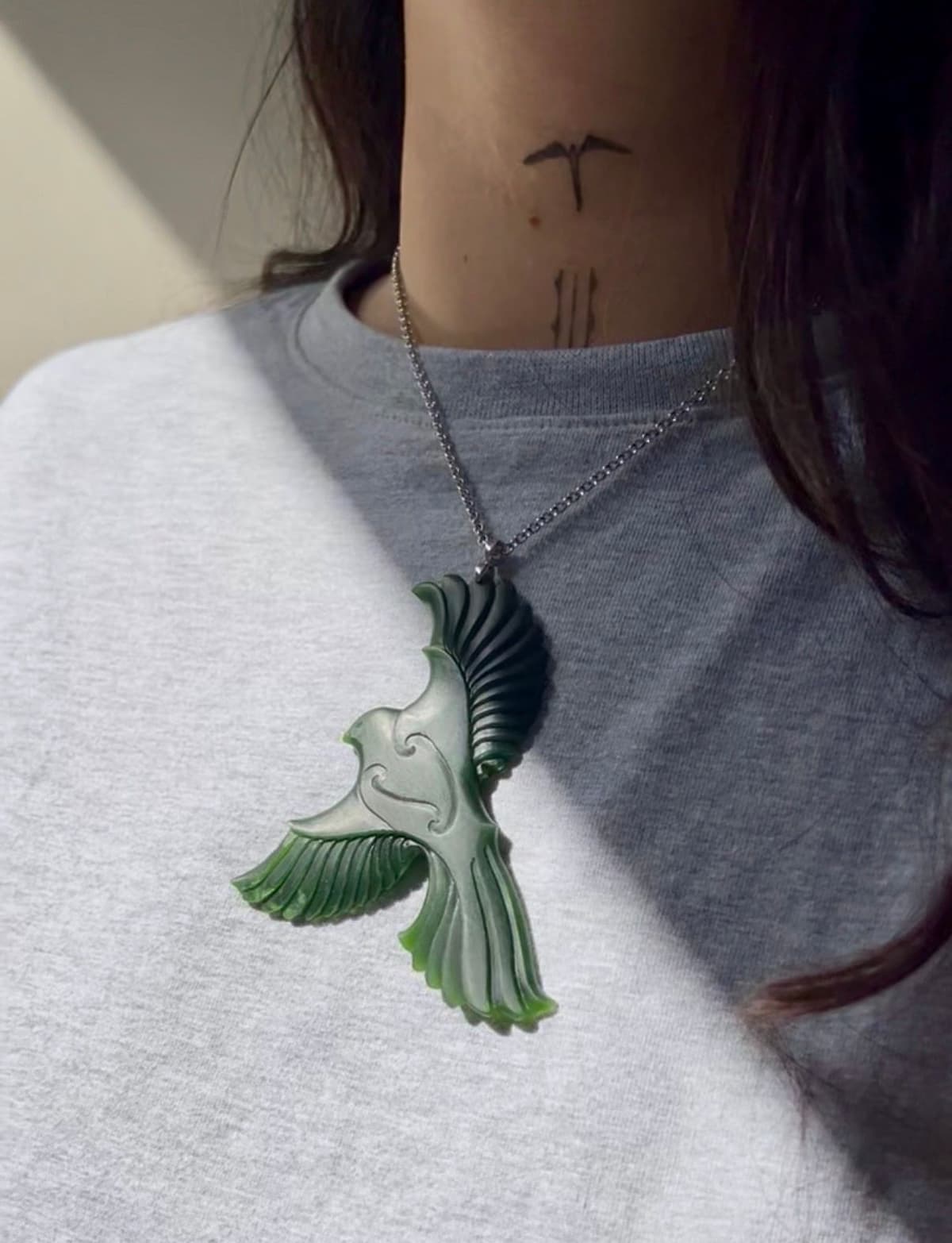 Contemporary Māori pounamu jewellery featuring a hand-carved native bird in flight, transforming authentic New Zealand greenstone into a bold statement necklace that connects Māori artistry with the natural world of Aotearoa.