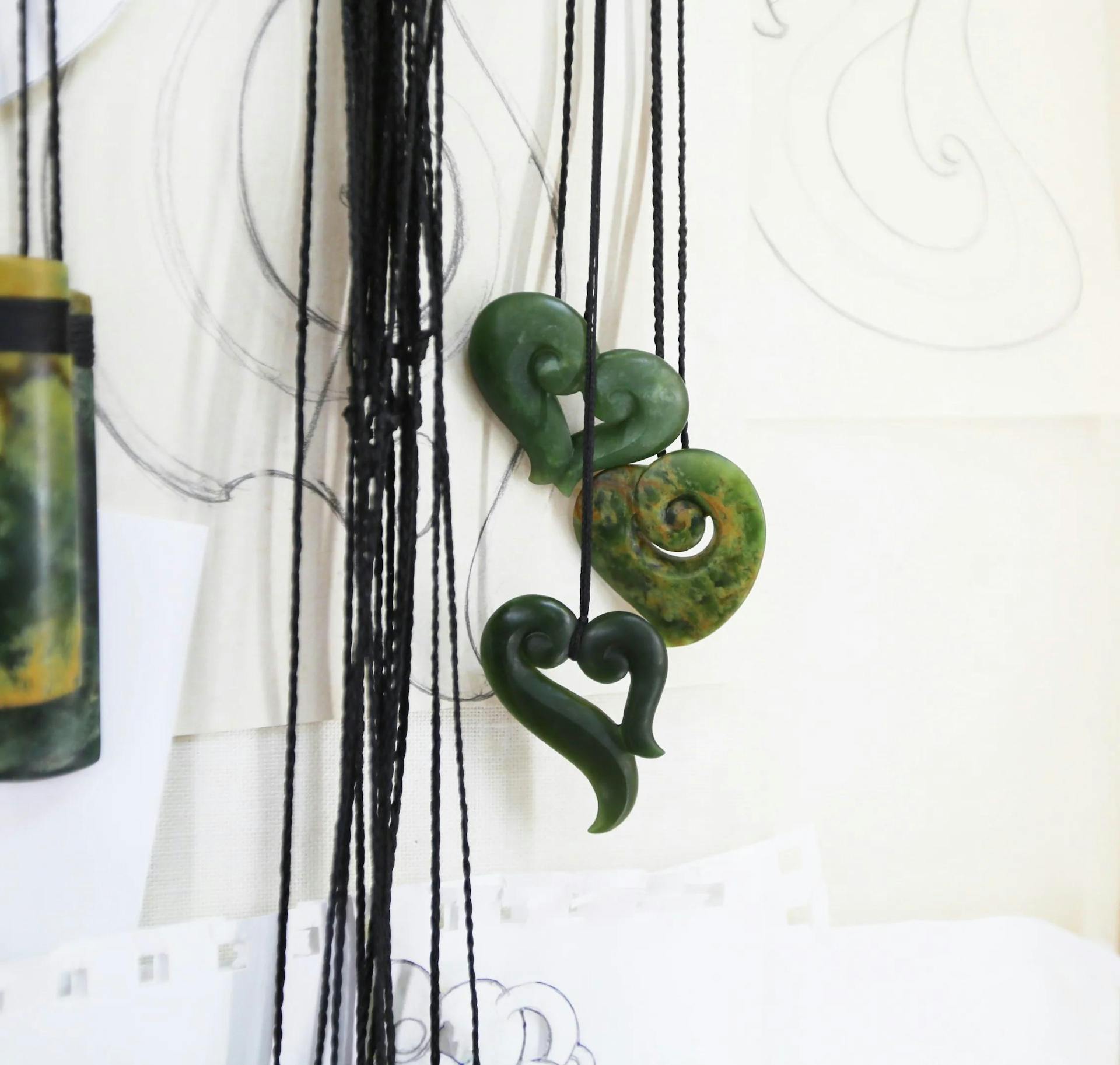 jade necklaces hanging from the wall