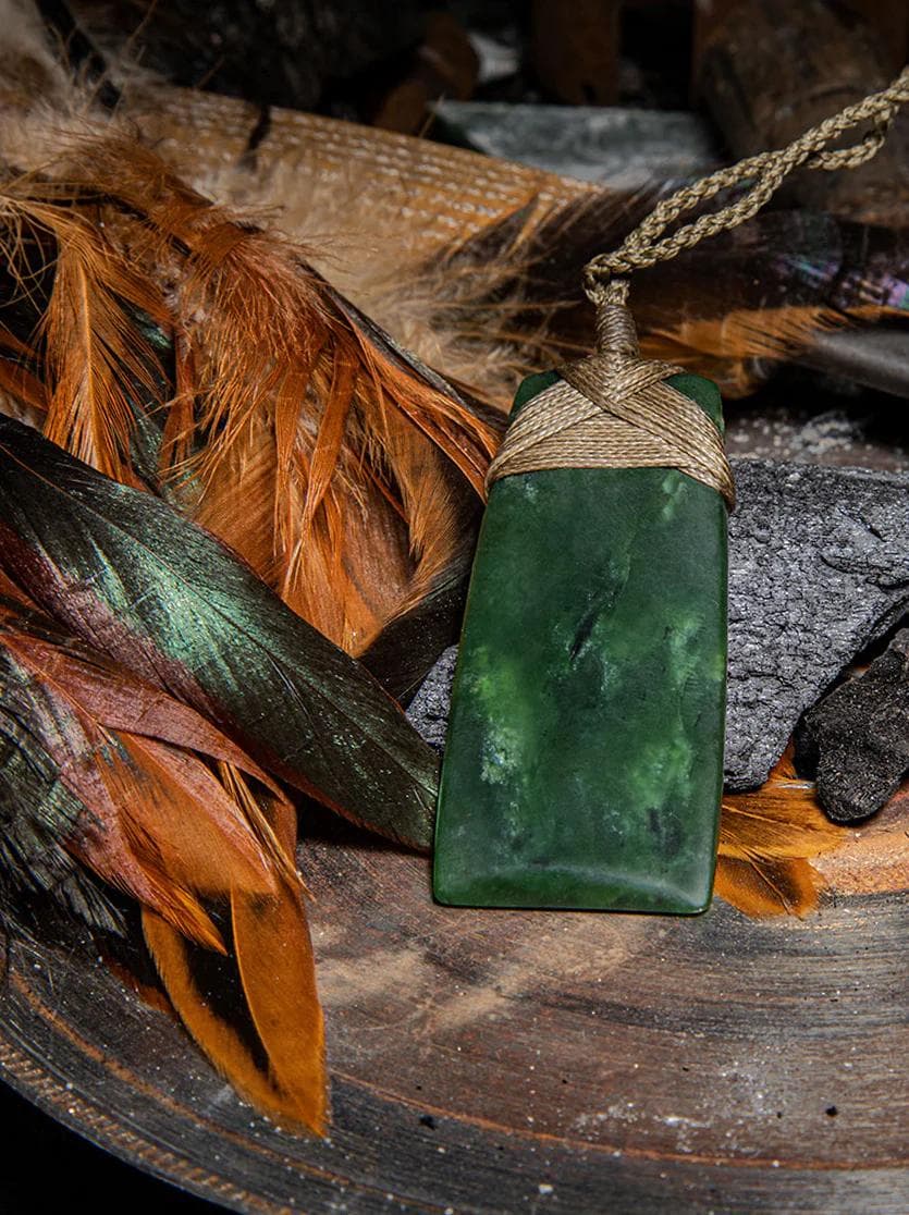 Toki pounamu among rocks and leaves